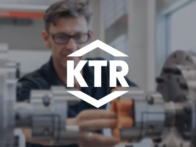 Engineer adjusting machinery with a KTR logo overlay, inside an industrial facility with large windows.
