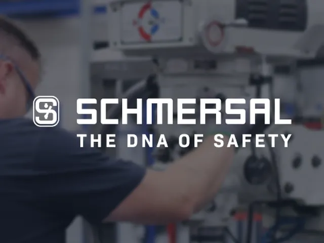 Worker adjusting a machine in a workshop; text reads "Schmersal - The DNA of Safety" with the company logo.