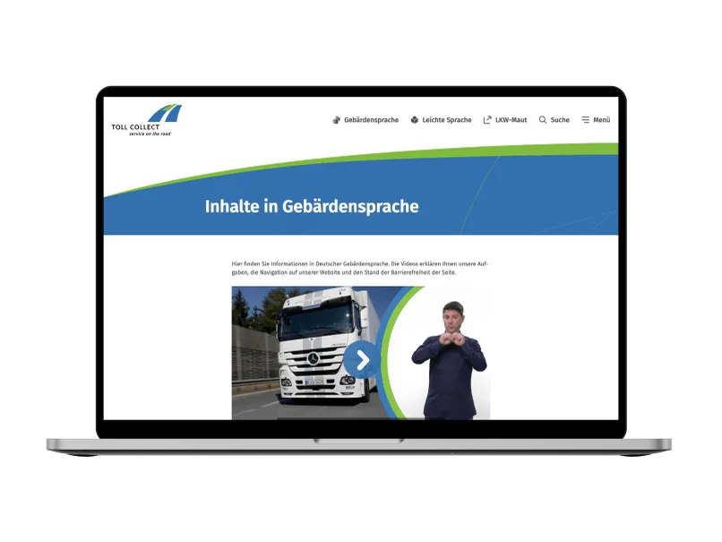Laptop mit geöffneter Webseite von Toll Collect, die barrierefreie Inhalte in Gebärdensprache zeigt. Bild eines LKWs und eines Mannes.